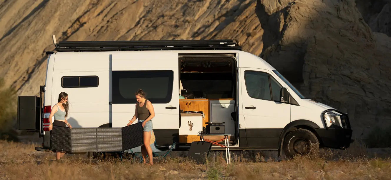 2 girls using solar generator for outdoor camping