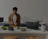 A woman uses portable power station to cook in the kitchen