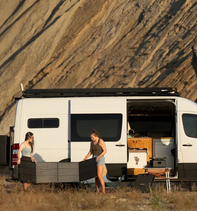 2 girls using solar generator in outdoor camping